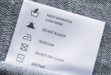 Label with washing instructions on gray knitted fabric