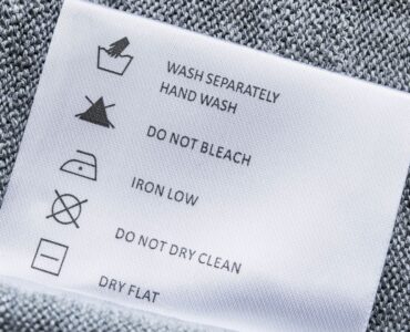 Label with washing instructions on gray knitted fabric